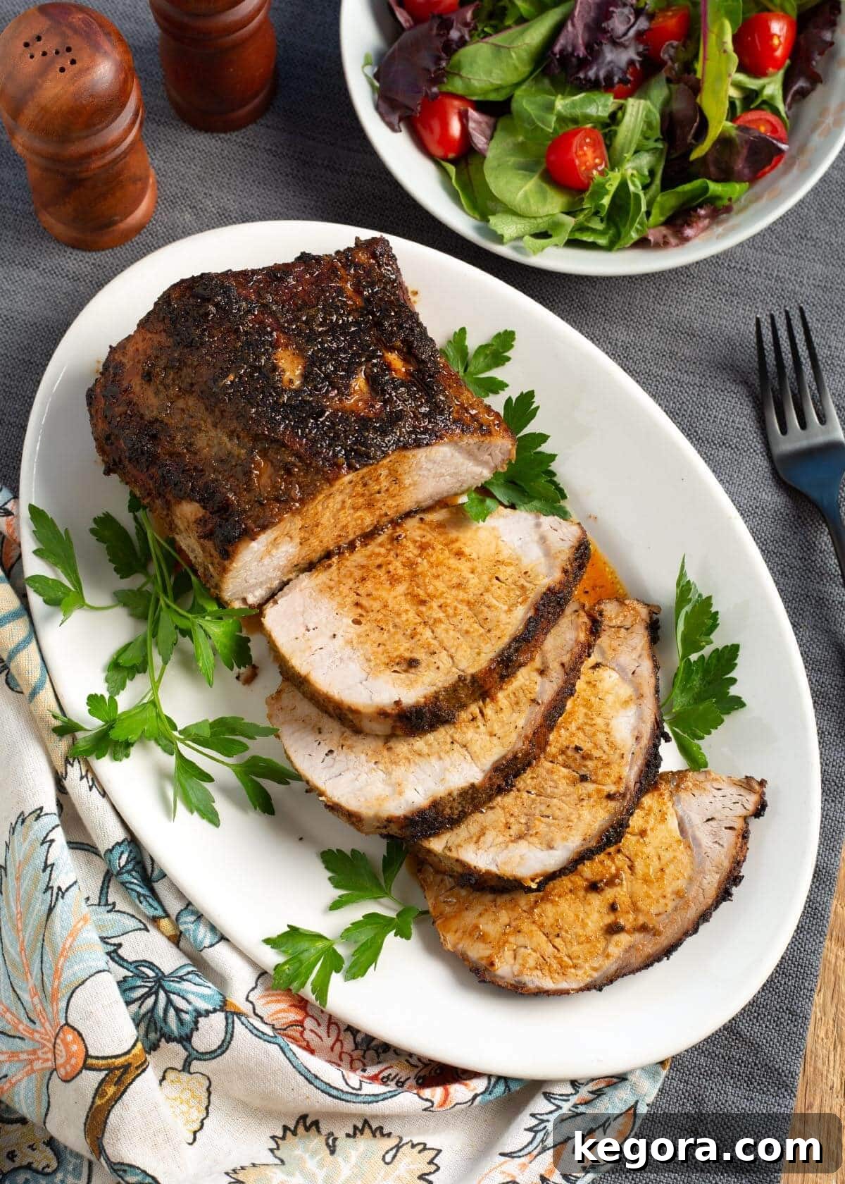 Air Fryer Pork Loin Roast on white platter, garnished