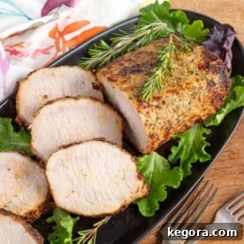 air fryer pork roast on black plate with slices and rosemary