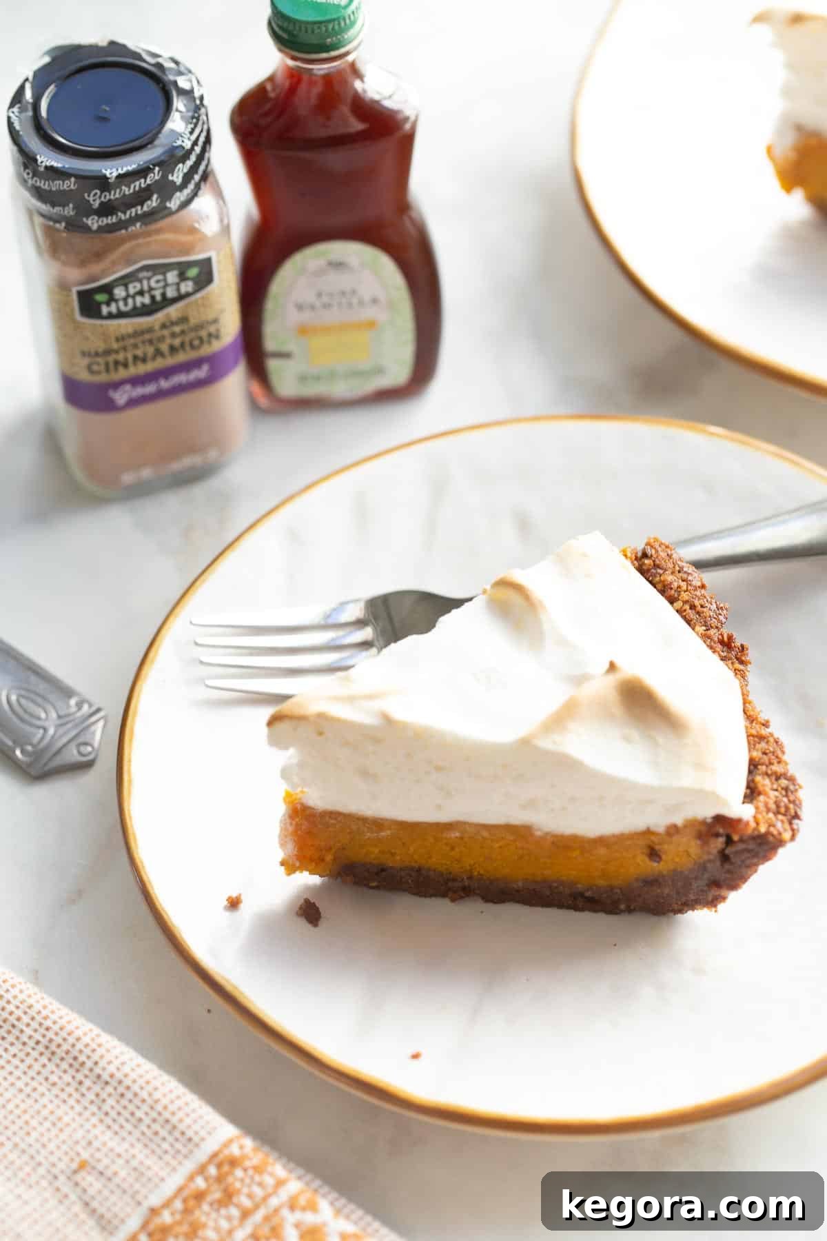 Gluten-Free Sweet Potato Pie Slice A beautifully presented slice of gluten-free sweet potato pie on a white plate, highlighting the fluffy meringue topping.
