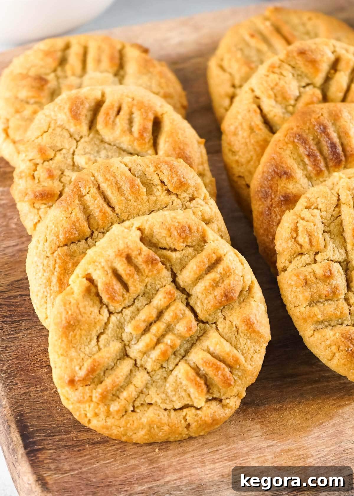 Air Fried Peanut Butter Cookie Delights 2 Perfectly baked Air Fryer Peanut Butter Cookies arranged in a row on a wooden board