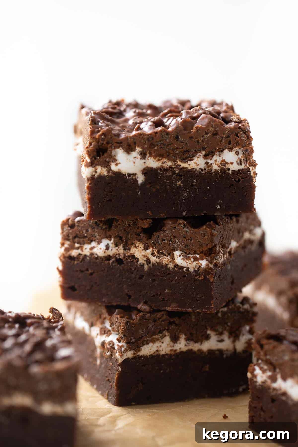 Gluten-Free Peanut Butter Crunch Brownies Shot of 3 gluten-free brownies stacked up, showcasing the layers of marshmallow and peanut butter crunch.