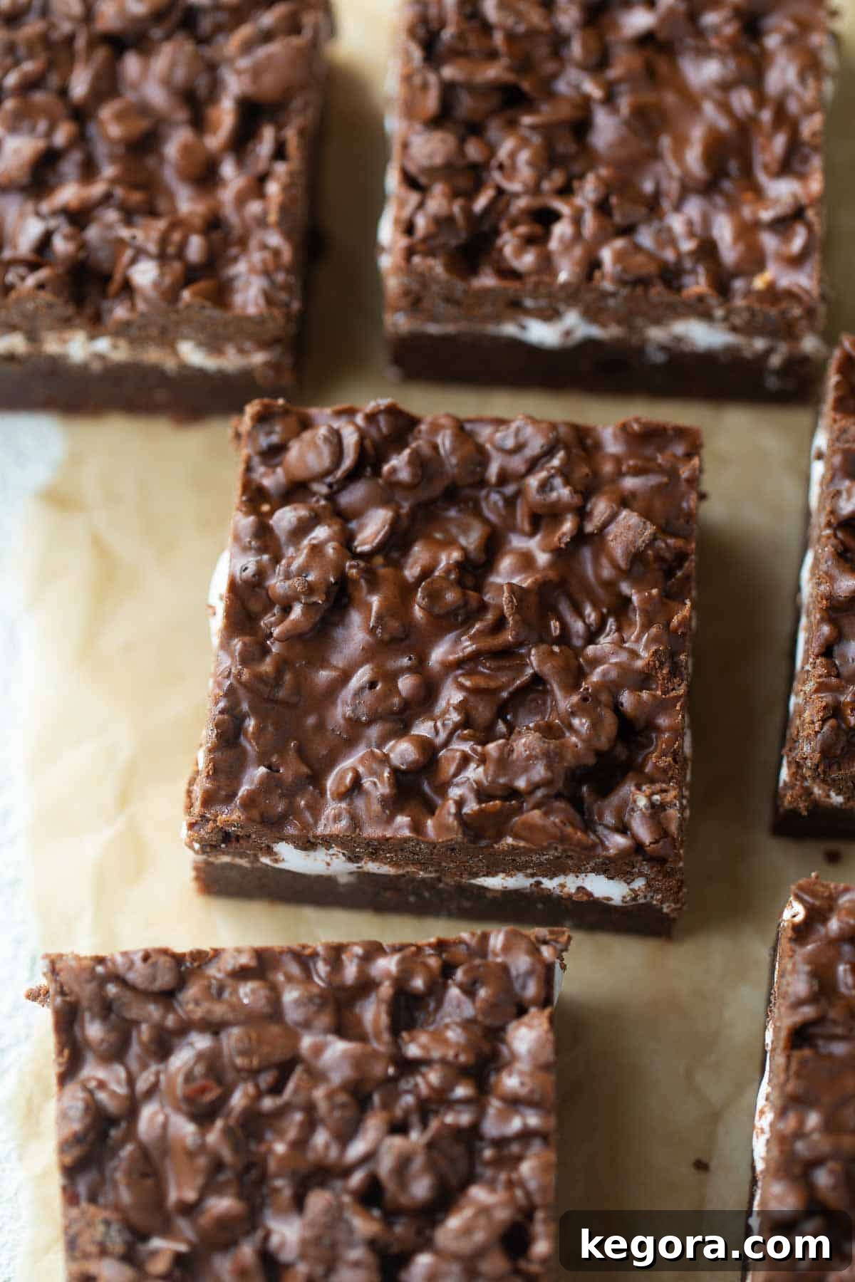 Gluten-Free PEBBLES Peanut Butter Crunch Brownies Up close shot of a single gluten-free peanut butter crunch brownie, showing the distinct layers.