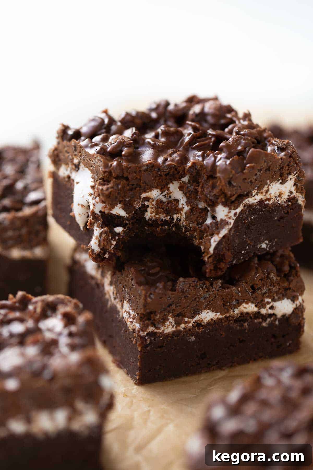 Gluten-Free PEBBLES™ Brownies Gluten-free peanut butter brownie with a bite taken out of it, revealing the chewy interior and crunchy top.