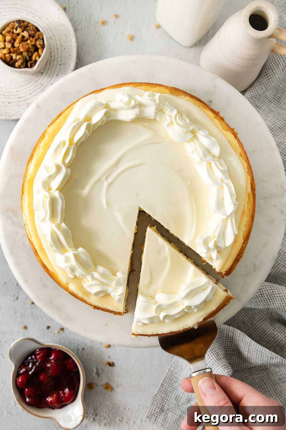 An overhead shot of a perfectly sliced gluten-free cheesecake on a white plate, showcasing its creamy texture.