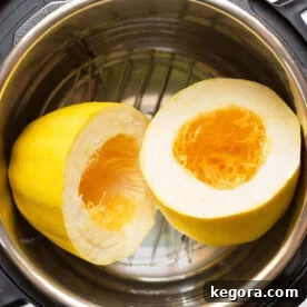 Instant Pot Spaghetti Squash cut in half on trivet, ready to be cooked in the pressure cooker.
