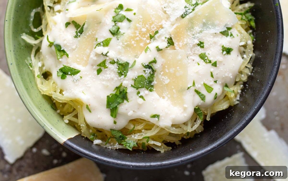 Velvety Garlic Parmesan Sauce 3 Garlic Parmesan Cream Sauce on spaghetti squash in bowl.