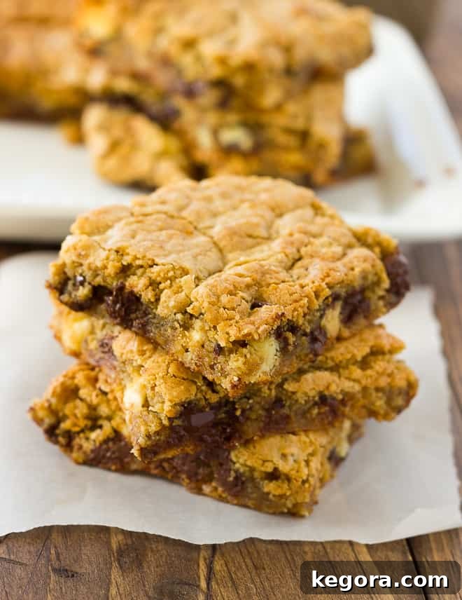 Delicious Almond Flour Blondies Gluten Free and Dairy Free 4 Three golden almond flour blondies arranged on white parchment paper, highlighting their perfect baked finish.