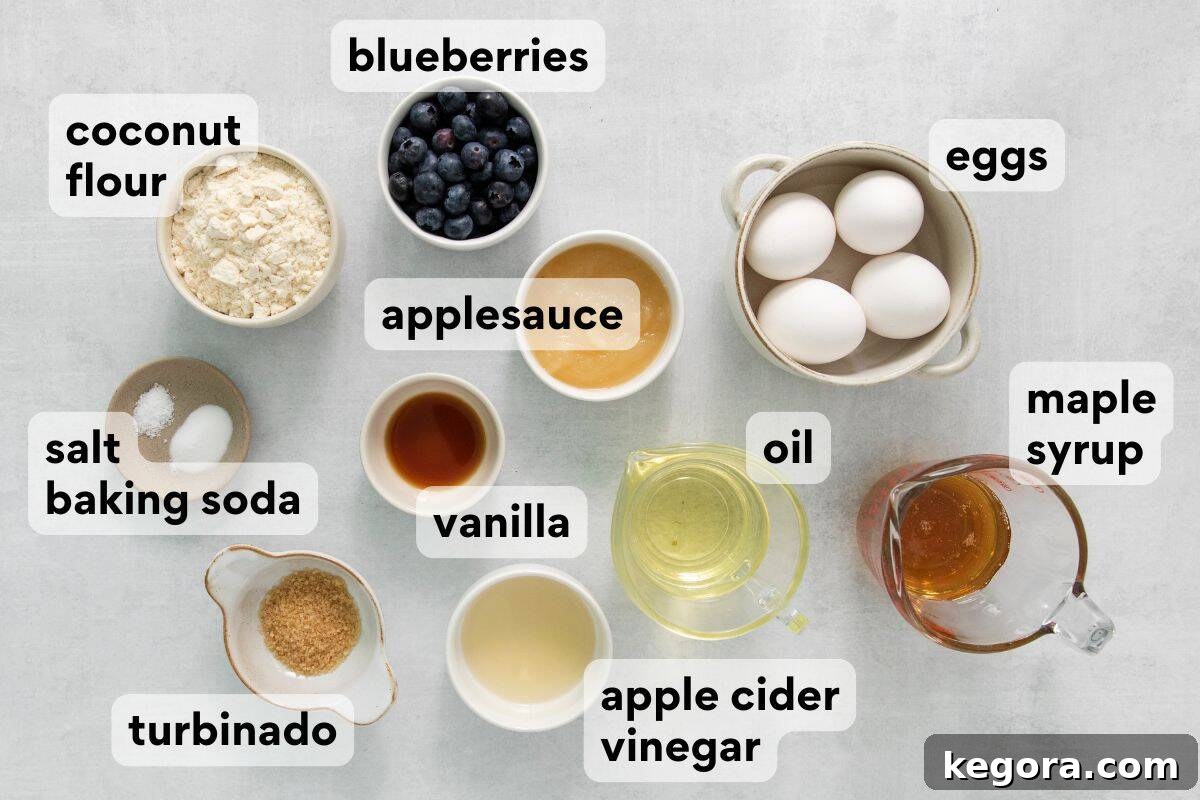 All ingredients for coconut flour blueberry muffins, measured and labeled in individual bowls.