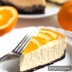 Slice of Pressure Cooker Dreamy Orange Cheesecake on a white plate with fork
