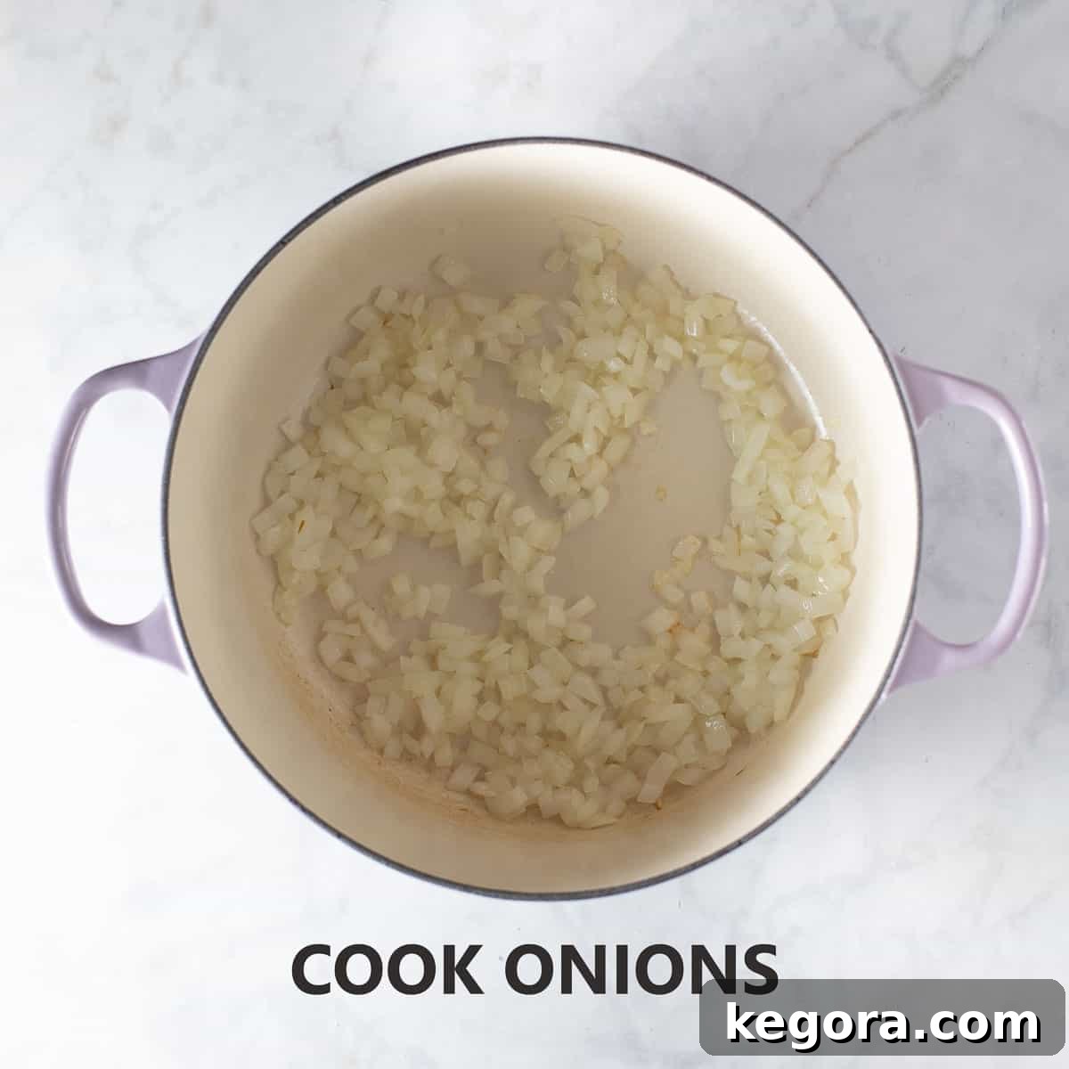 Guilt-Free Sloppy Joes 4 Chopped onions gently cooking in olive oil in a large pot on the stove until they become soft and translucent, preparing the aromatic base for the sloppy joe sauce.