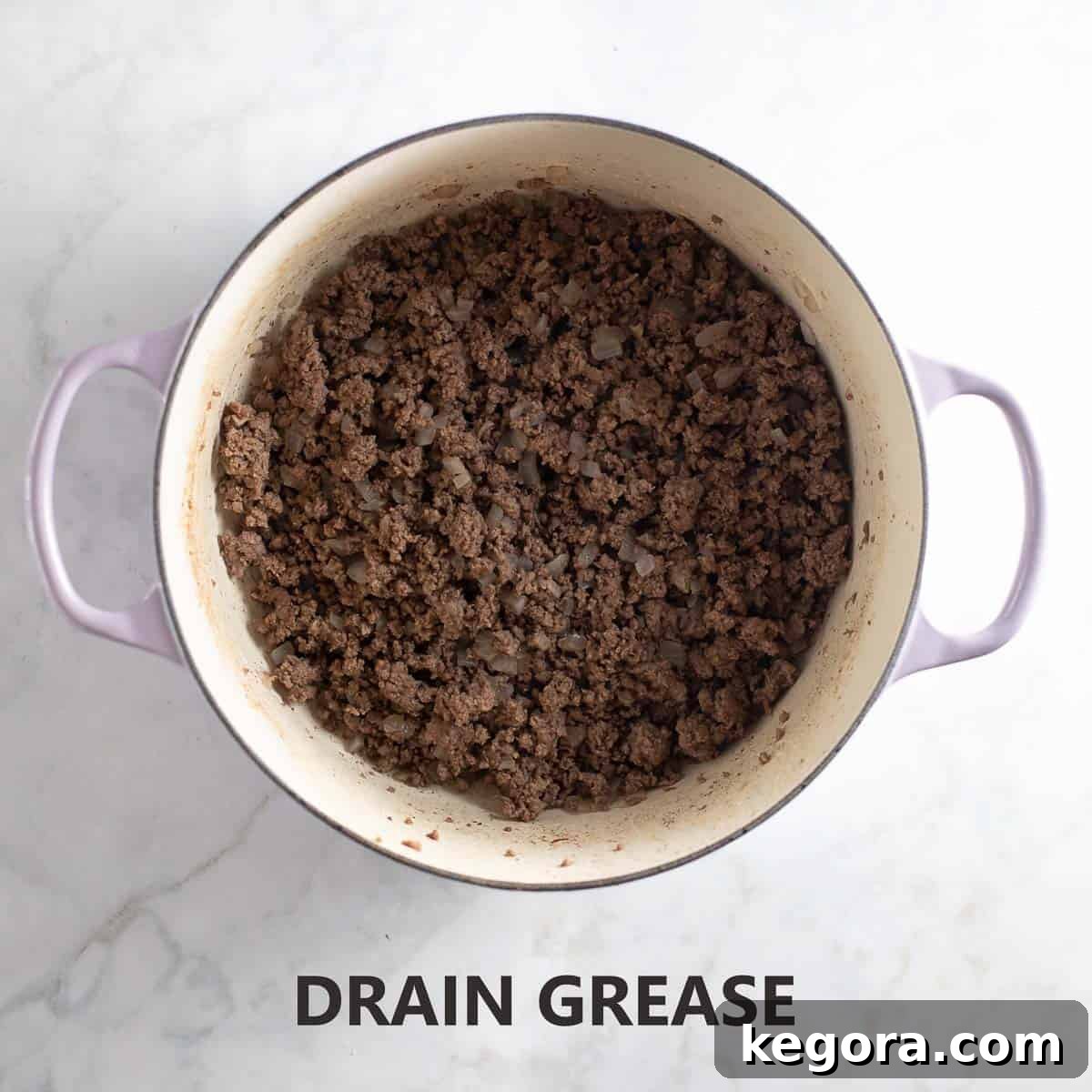 Guilt-Free Sloppy Joes 6 Cooked ground meat and onions in the pot after excess grease has been drained, ensuring a leaner and more flavorful sloppy joe mixture.