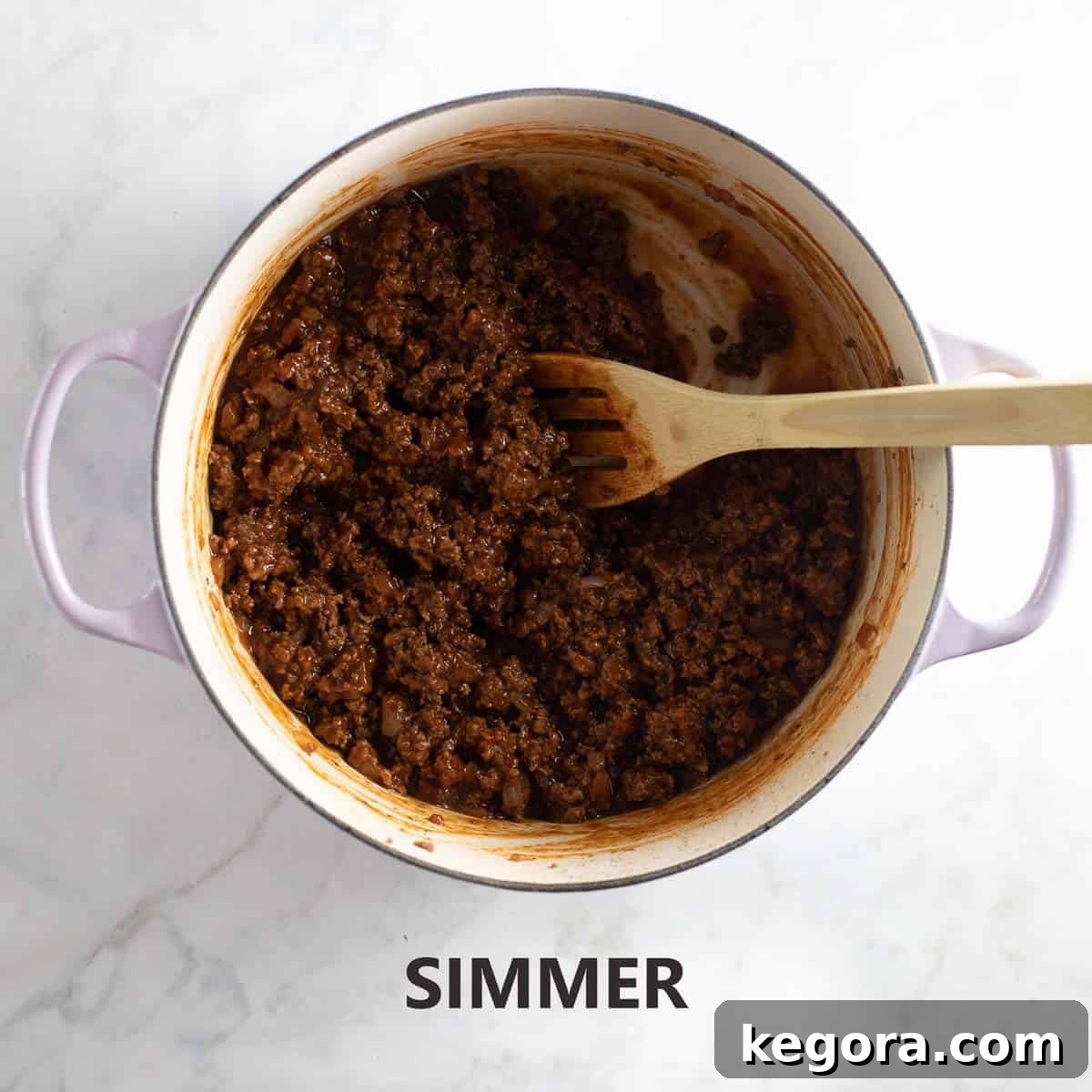 Guilt-Free Sloppy Joes 8 The sloppy joe mixture gently simmering in a vibrant purple pot, allowing the flavors to meld and the sauce to thicken to the perfect consistency.