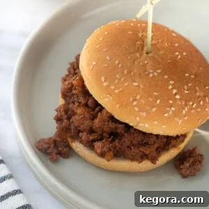 Guilt-Free Sloppy Joes 10 A delicious gluten-free sloppy joe served on a toasted bun on a gray plate, ready to be enjoyed.