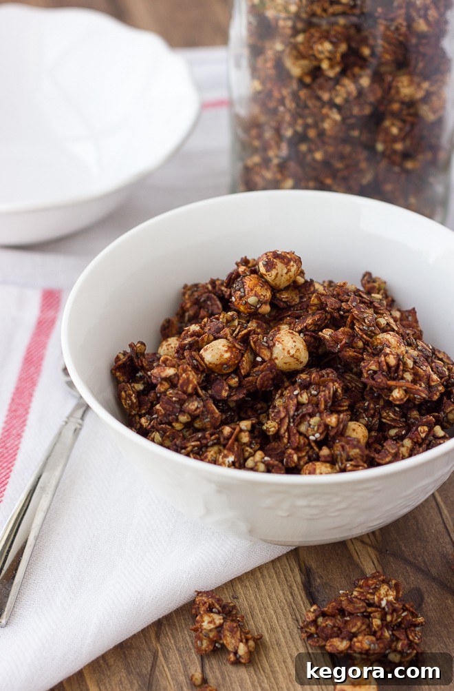 Decadent Chocolate Hazelnut Granola Gluten and Dairy Free 2 Crispy Chocolate Hazelnut Granola in a white bowl with a spoon