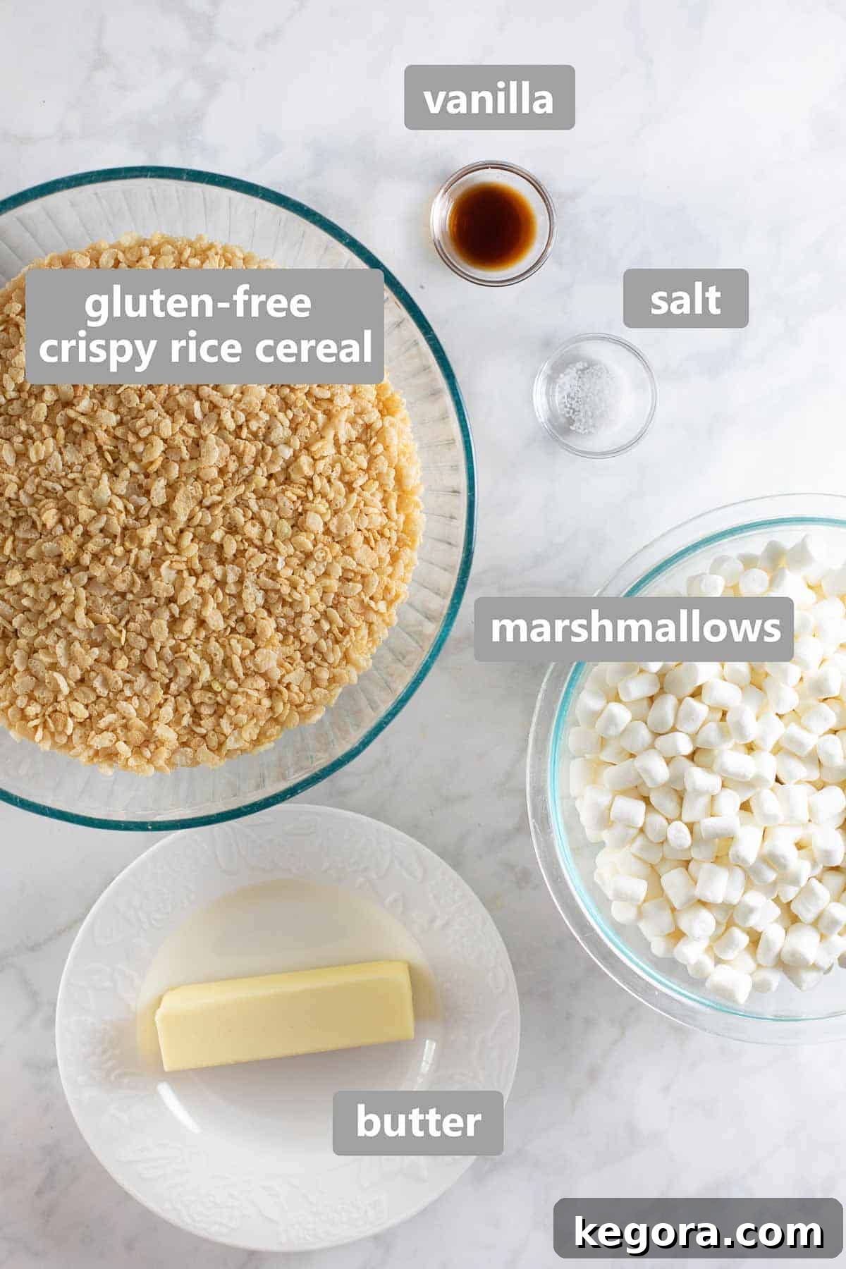 Collection of ingredients required to make gluten-free crispy rice cereal treats, including marshmallows, butter, and vanilla.