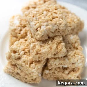 Stack of crispy treats on a white plate, showcasing a delicious gluten-free dessert.