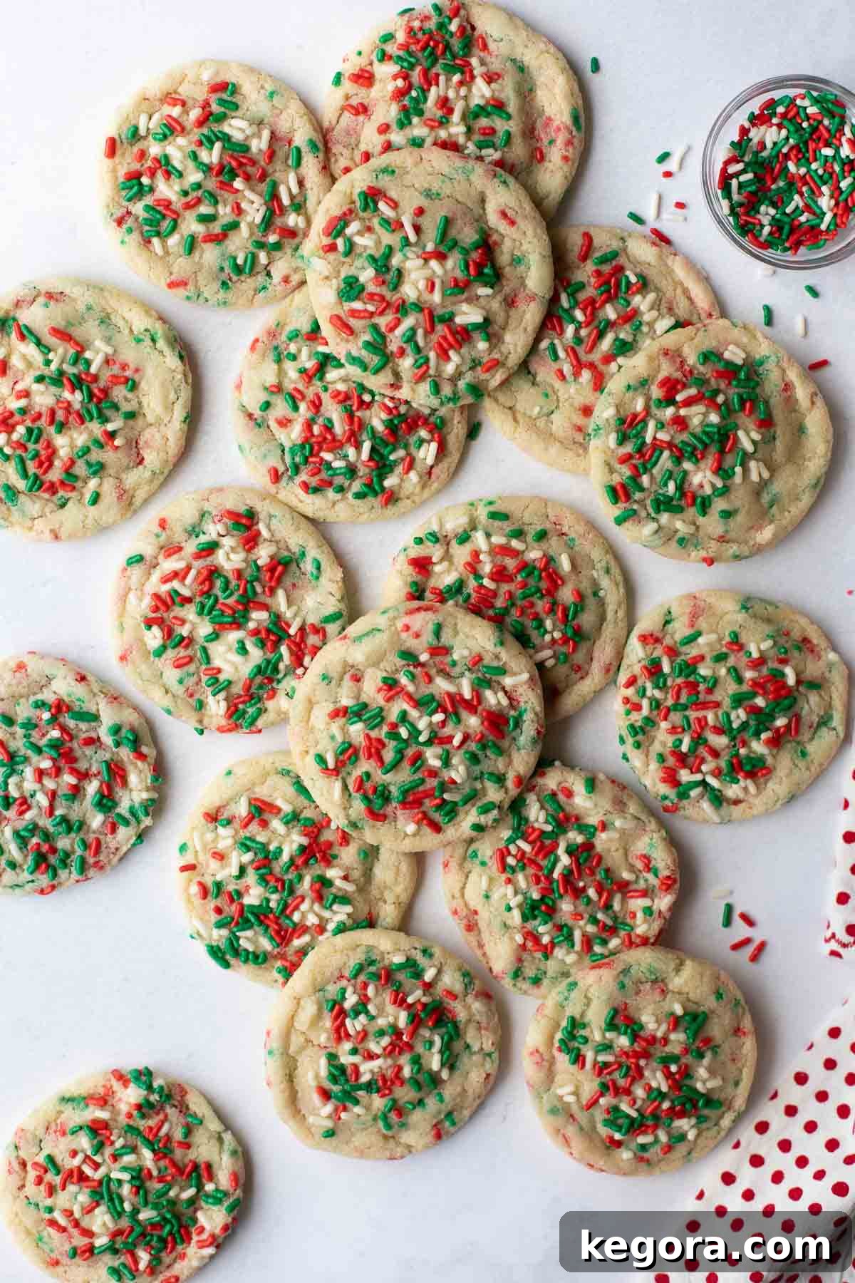Sparkling Gluten-Free Christmas Treats 2 overhead shot of assorted gluten-free Christmas cookies on a festive marble background, beautifully arranged with a scattering of sprinkles