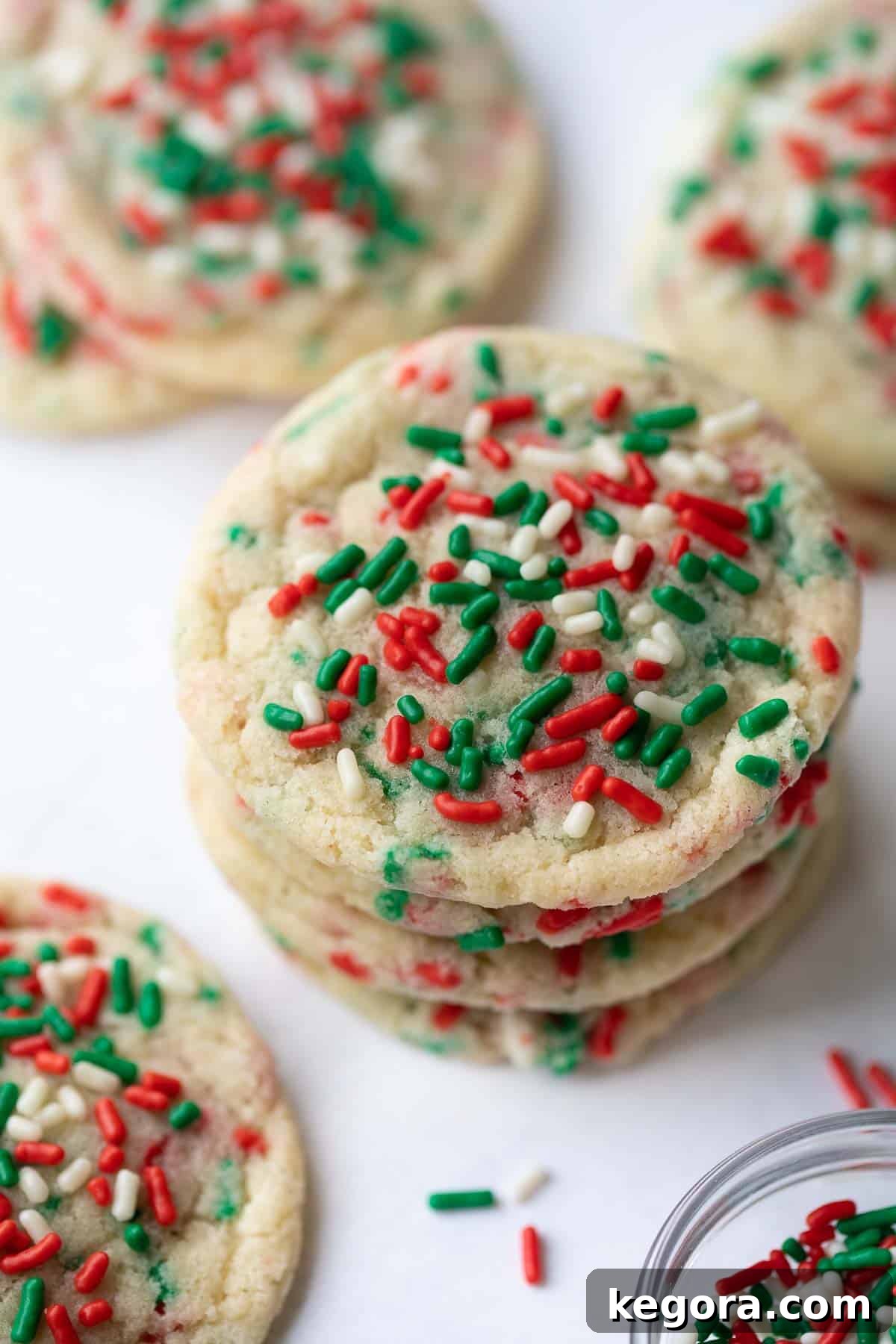 Sparkling Gluten-Free Christmas Treats 9 close up shot of a beautifully baked gluten-free Christmas cookie, showcasing its soft texture and perfectly melted sprinkles on a marble background