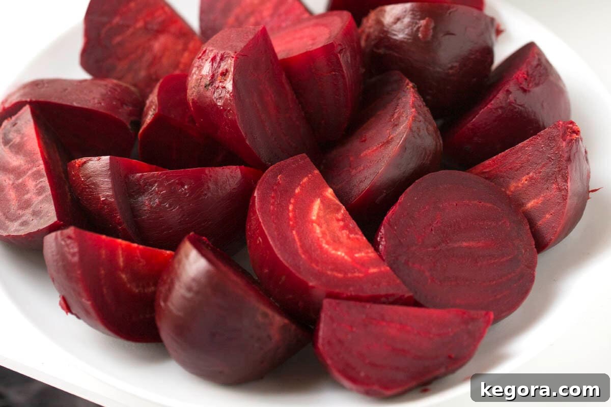 Perfect Instant Pot Beets 3 instant pot beets on a white plate.