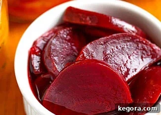 Perfect Instant Pot Beets 6 pickled instant pot beets in a small white bowl.