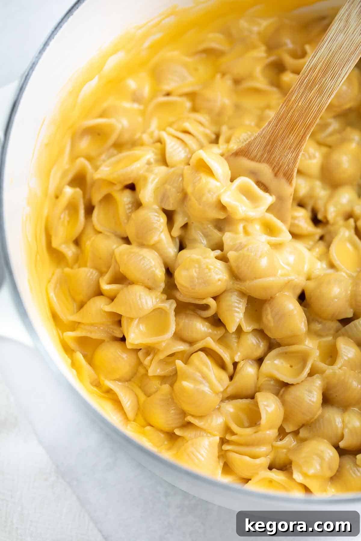 Decadent Gluten-Free Mac and Cheese 2 Close-up of creamy gluten-free mac and cheese in a white pot with a serving spoon
