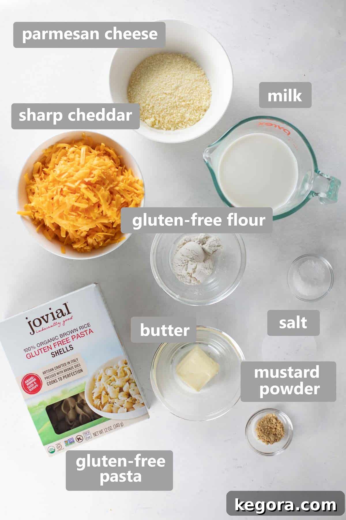 Decadent Gluten-Free Mac and Cheese 3 Overhead view of fresh ingredients for homemade gluten-free mac and cheese: pasta, milk, cheese, butter, flour, and spices