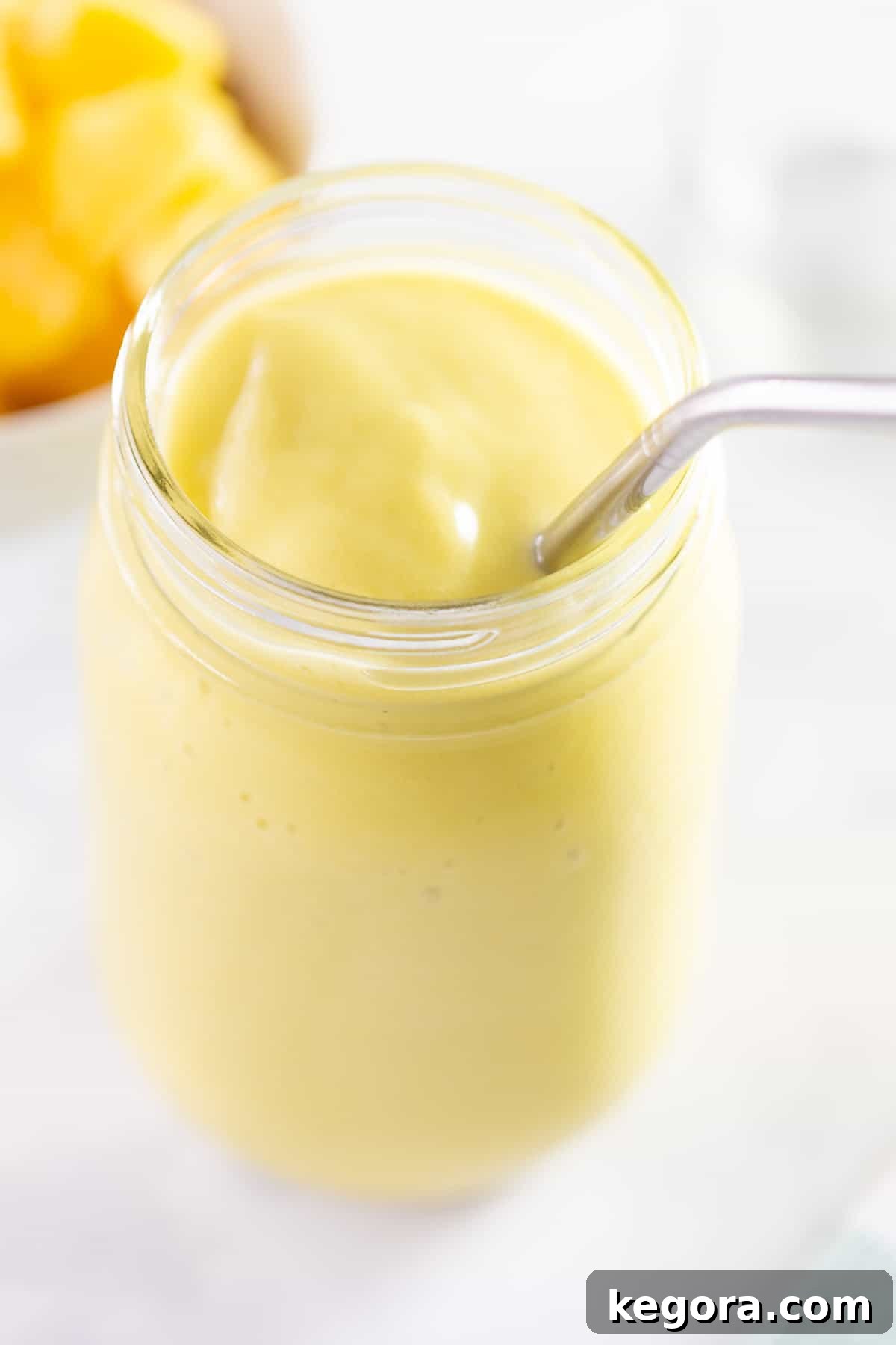 Close-up of a refreshing mango avocado smoothie, highlighting its smooth and creamy texture.