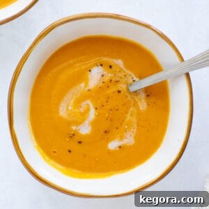 A perfectly portioned bowl of creamy roasted sweet potato soup, garnished with a sprinkle of pepper, ready to be enjoyed.