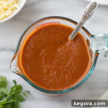 close up shot of enchilada sauce in glass measuring cup