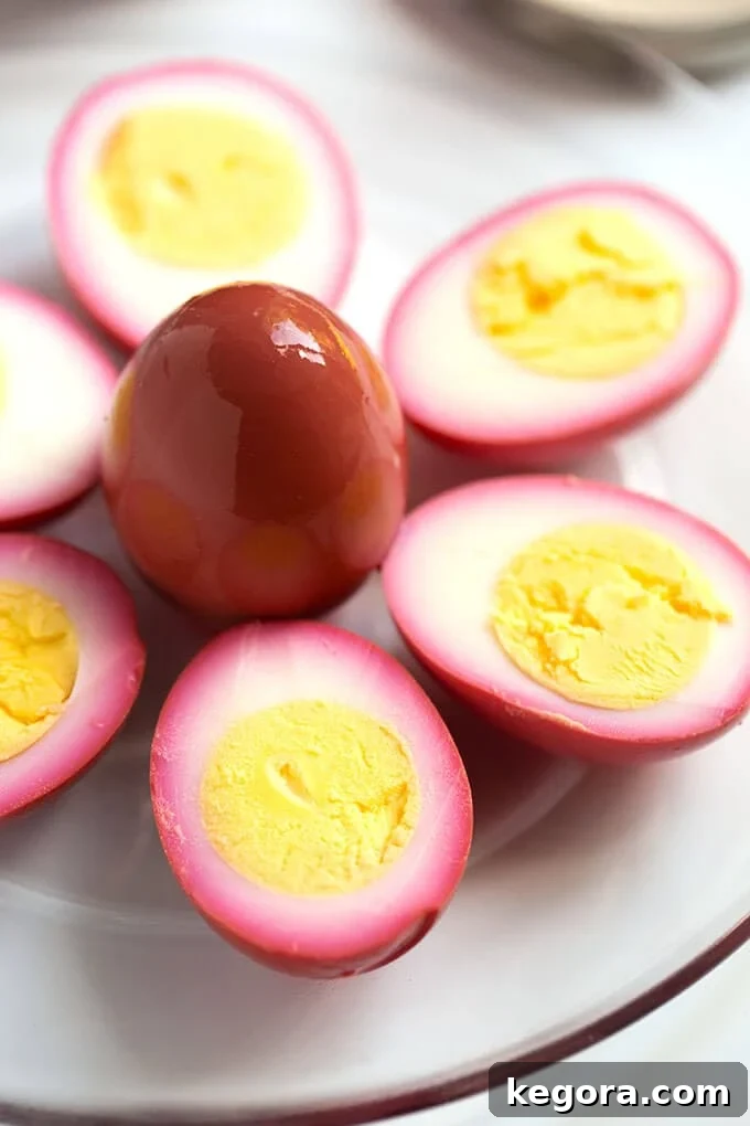 Halved pickled eggs on white plate with yoke side up