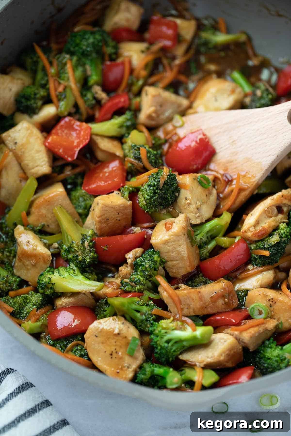 Flavorful Gluten-Free Chicken Stir-Fry 7 stir fry in skillet with wooden spoon