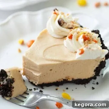 slice of peanut butter pie with gluten free oreo crust on a white plate