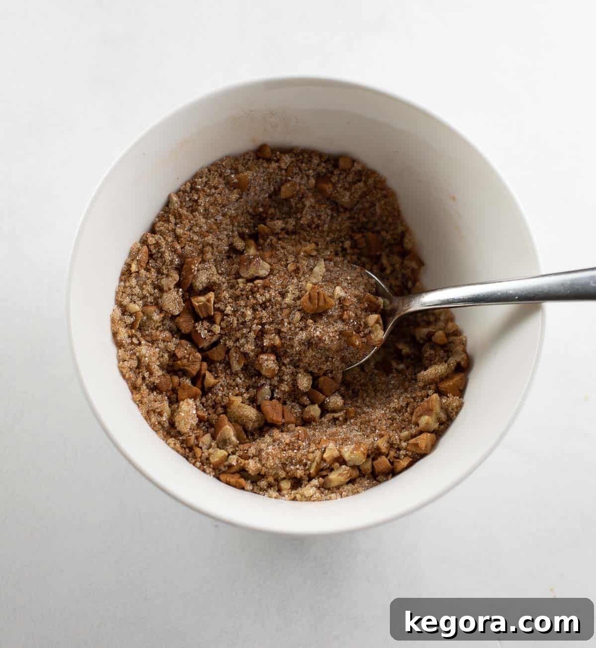 Close-up of the delicious cinnamon nut mixture, perfectly prepared to be sprinkled generously over the coffee cake for a delightful topping.
