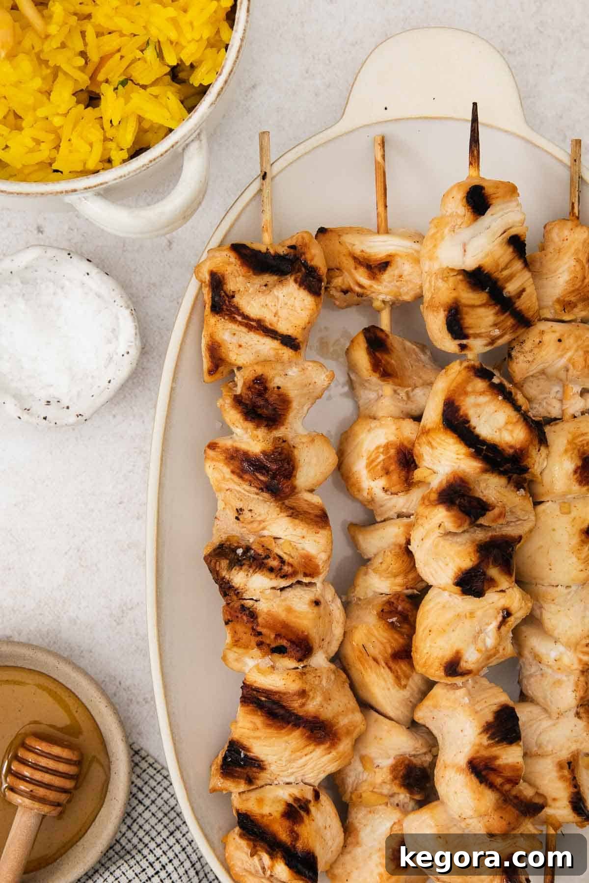 Sticky Honey Sesame Chicken Skewers Gluten and Dairy Free 3 Delicious honey sesame chicken skewers and vegetable skewers artfully arranged on a serving platter.