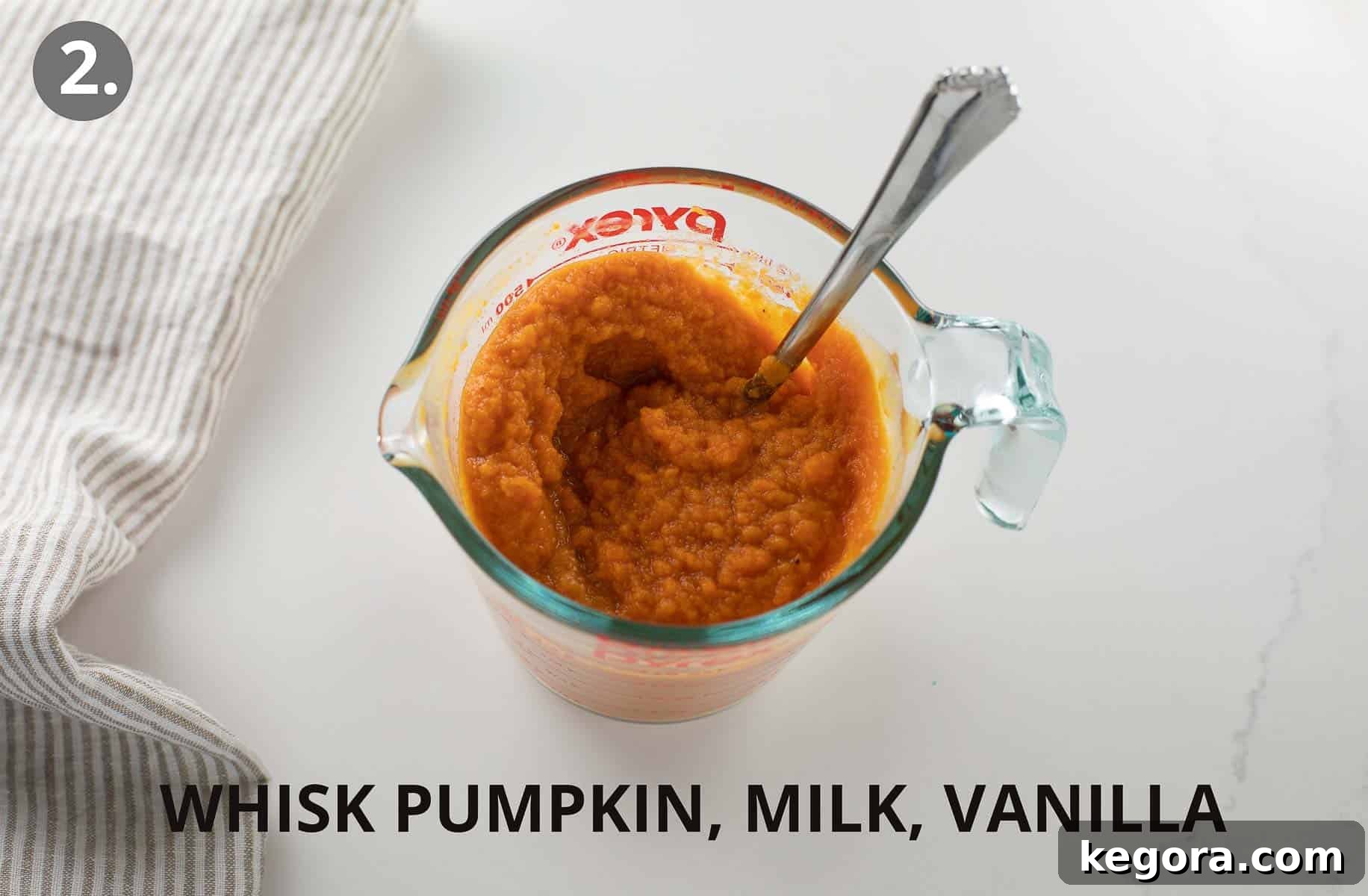 Guilt-Free Autumn Pumpkin Bars 5 Pumpkin puree, milk, and vanilla extract are mixed together in a glass measuring cup, ready to be added to the batter.