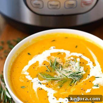 Homemade Pumpkin Puree Your Way Instant Pot Oven or Slow Cooker 9 Butternut Squash Soup in a white bowl garnished with rosemary with pressure cooker in background