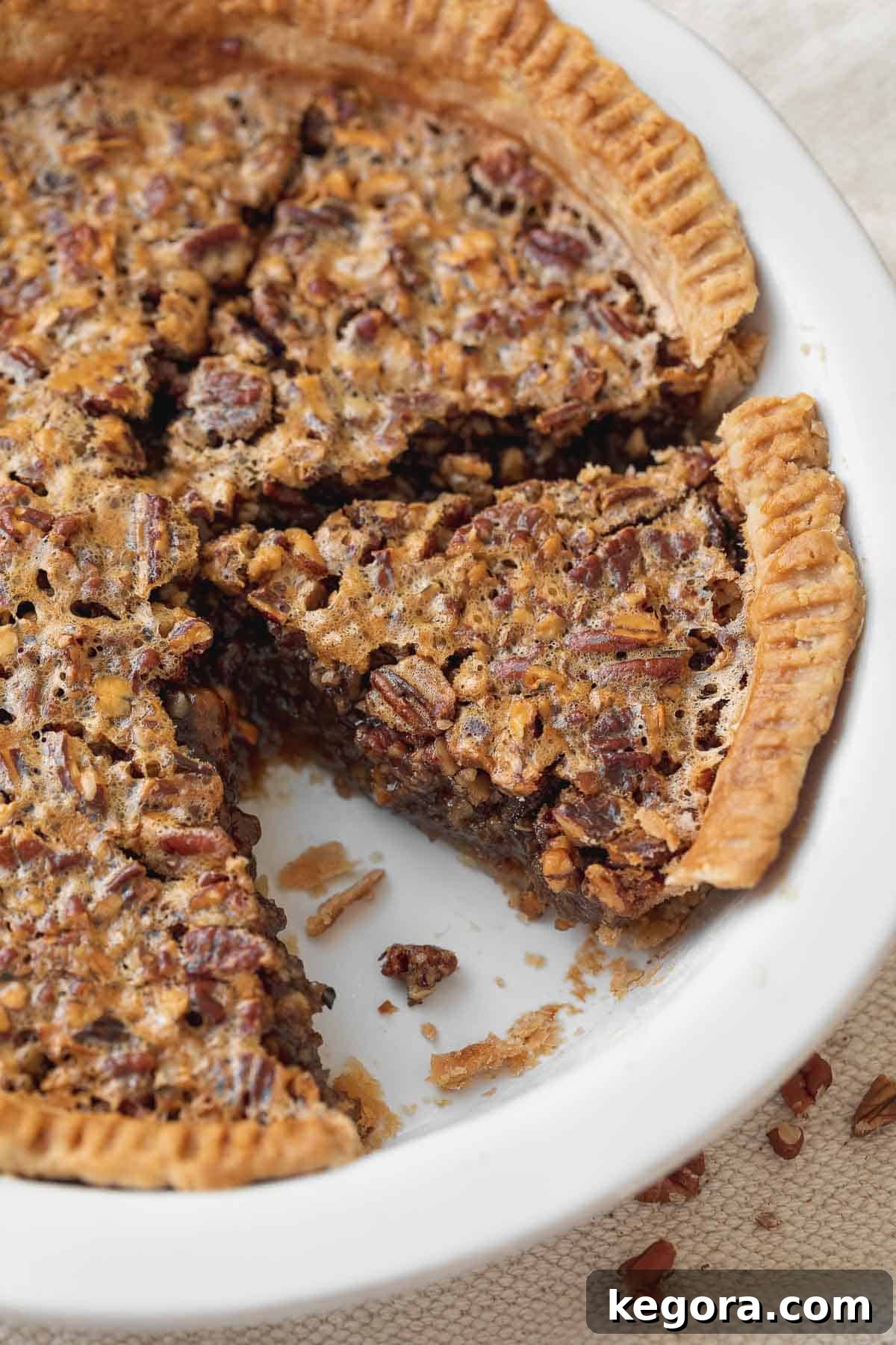 Decadent Gluten-Free Pecan Pie 11 close up picture of pecan pie in white serving dish