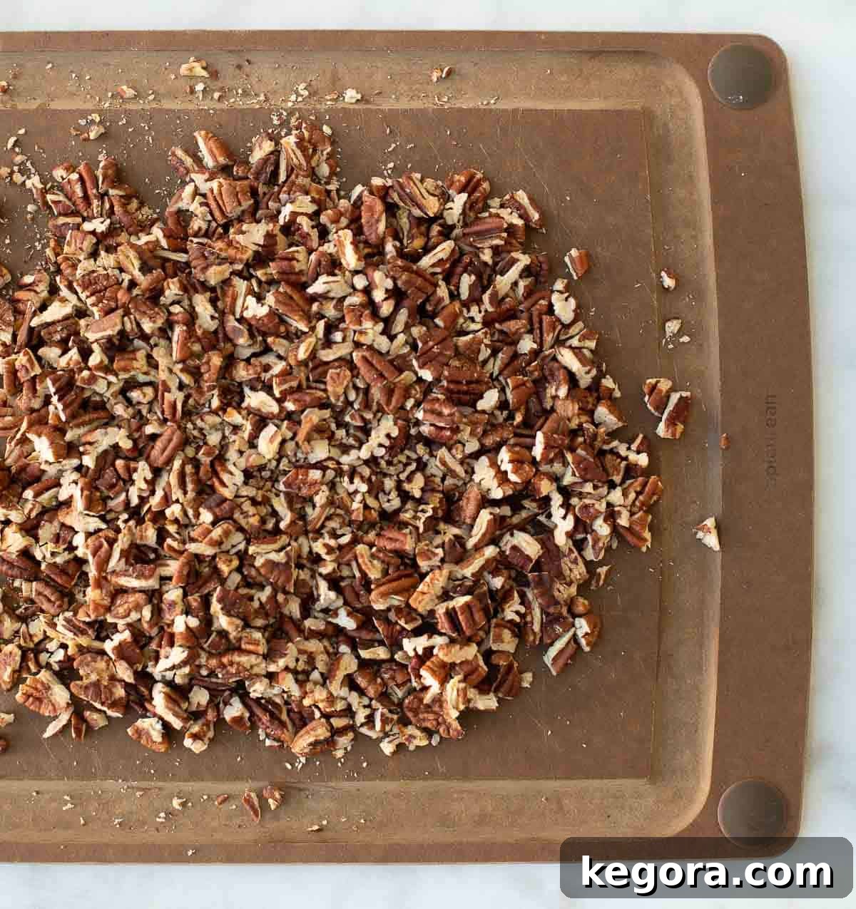 Decadent Gluten-Free Pecan Pie 8 chopped toasted pecans on wood cutting board