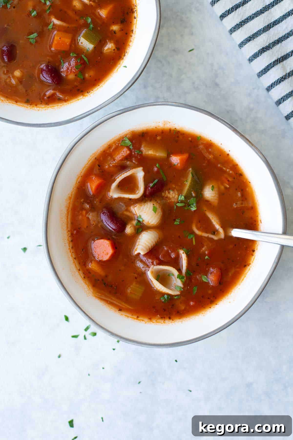 Gluten-Free Minestrone Soup overhead shot of minestrone soup in a bowl, garnished with fresh herbs