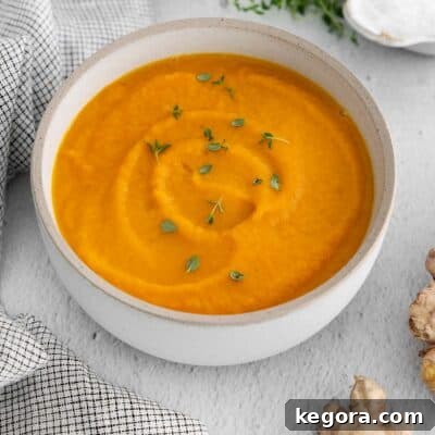 A beautifully presented bowl of creamy carrot ginger soup.
