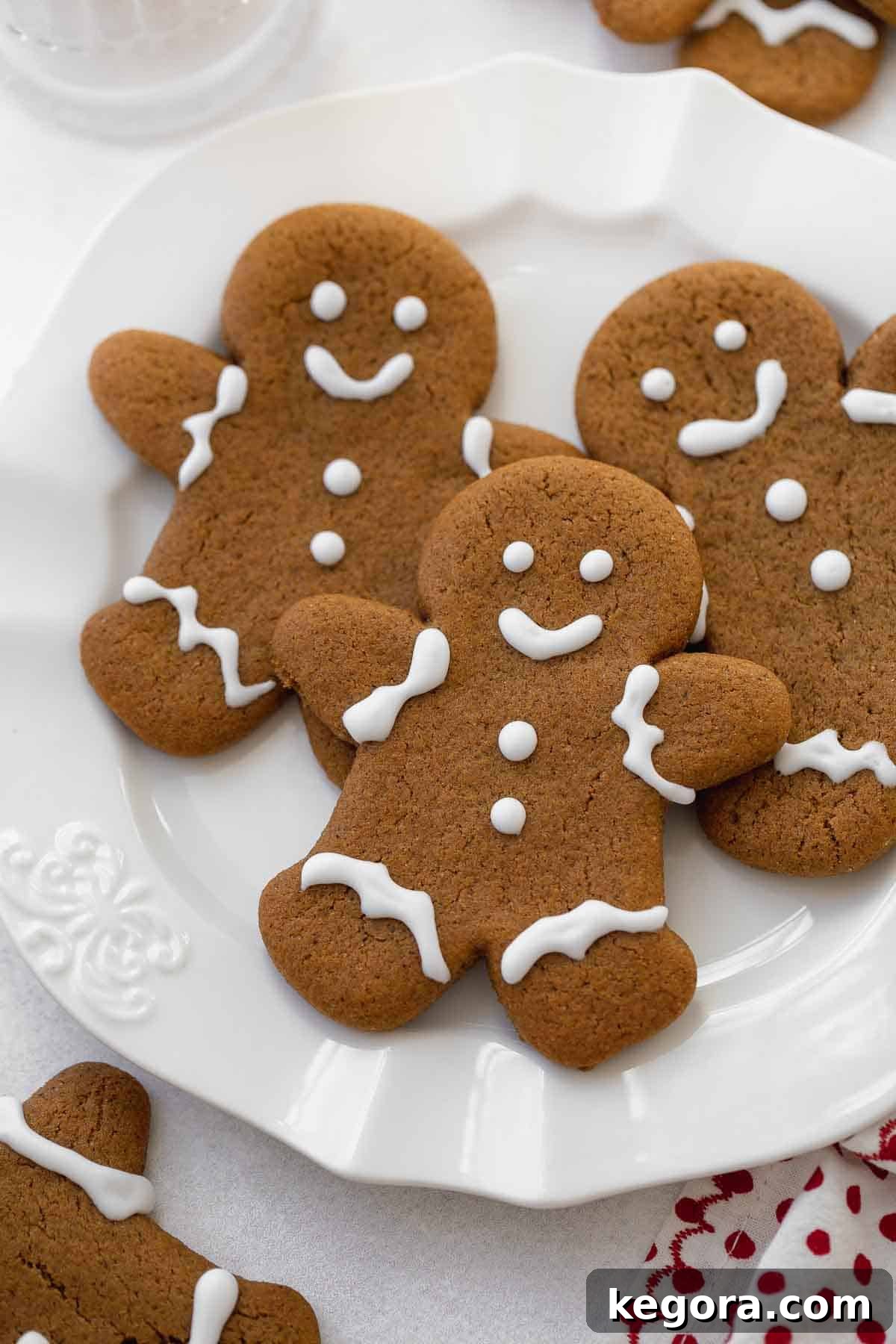 Spiced Gluten Free Gingerbread Delights 11 Close-up of soft, gluten-free gingerbread cookies on a white plate, showcasing their perfect texture and inviting golden-brown color.