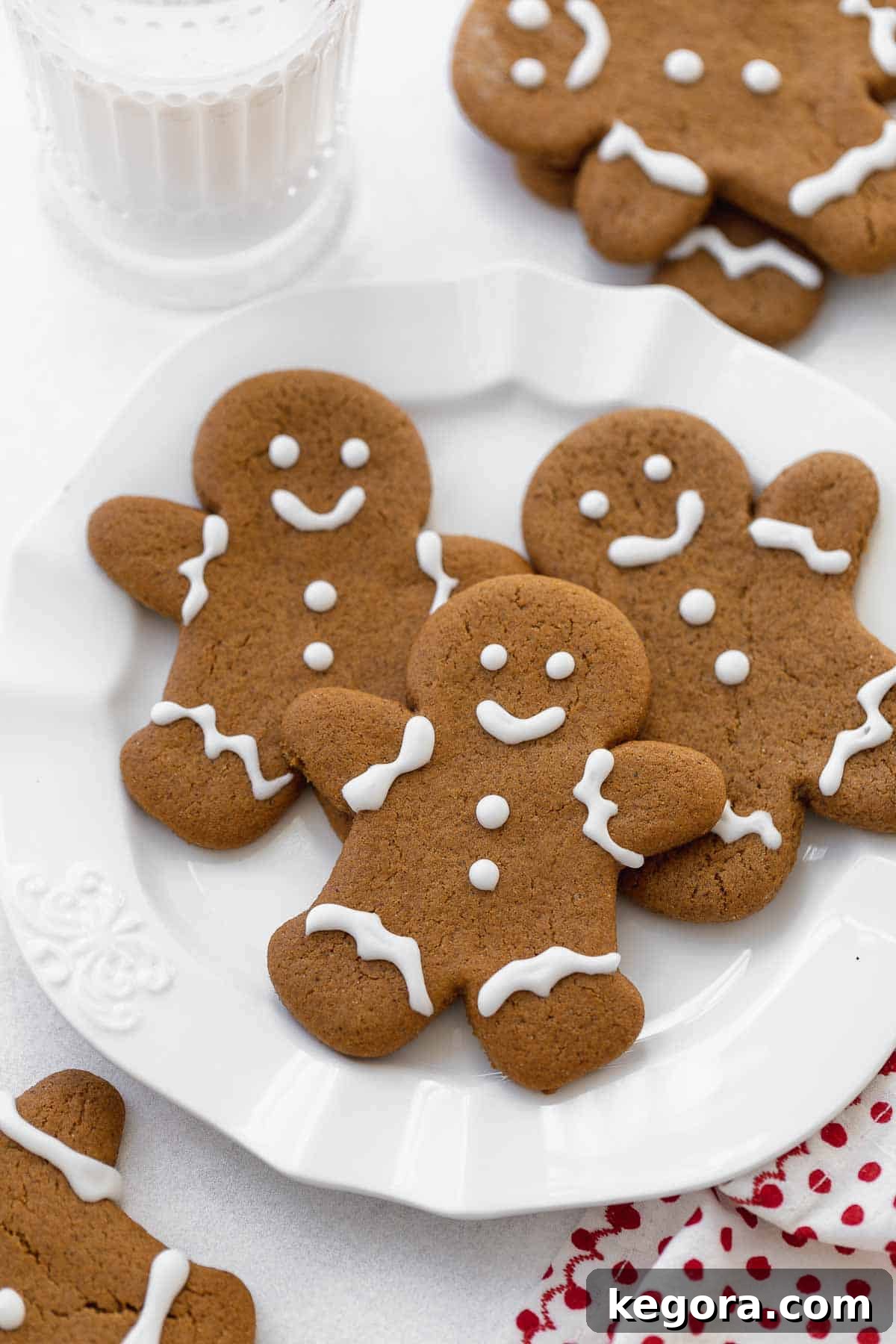 Spiced Gluten Free Gingerbread Delights 3 A plate of perfectly baked gluten free gingerbread cookies next to a glass of milk, ready for the holidays.