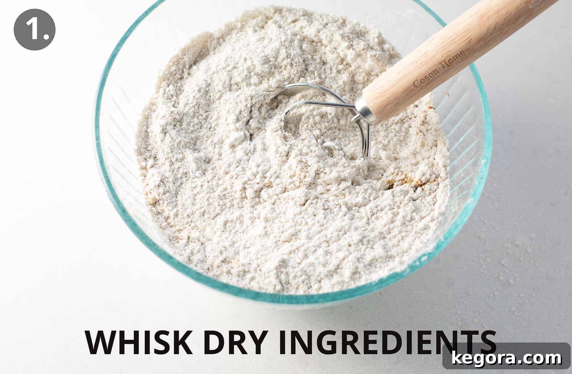 Spiced Gluten Free Gingerbread Delights 5 Dry ingredients for gluten-free gingerbread cookies being whisked together in a clear glass bowl, ensuring even distribution of spices.