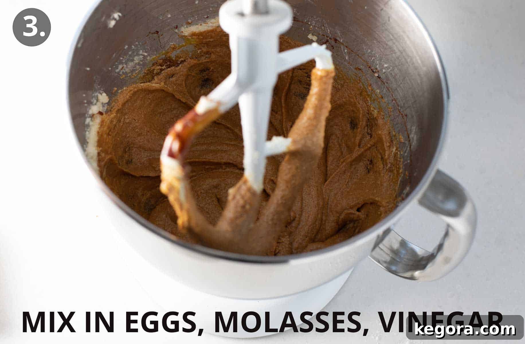 Spiced Gluten Free Gingerbread Delights 7 Wet ingredients including egg, molasses, and vinegar being mixed into the creamed shortening and sugar in a stand mixer.