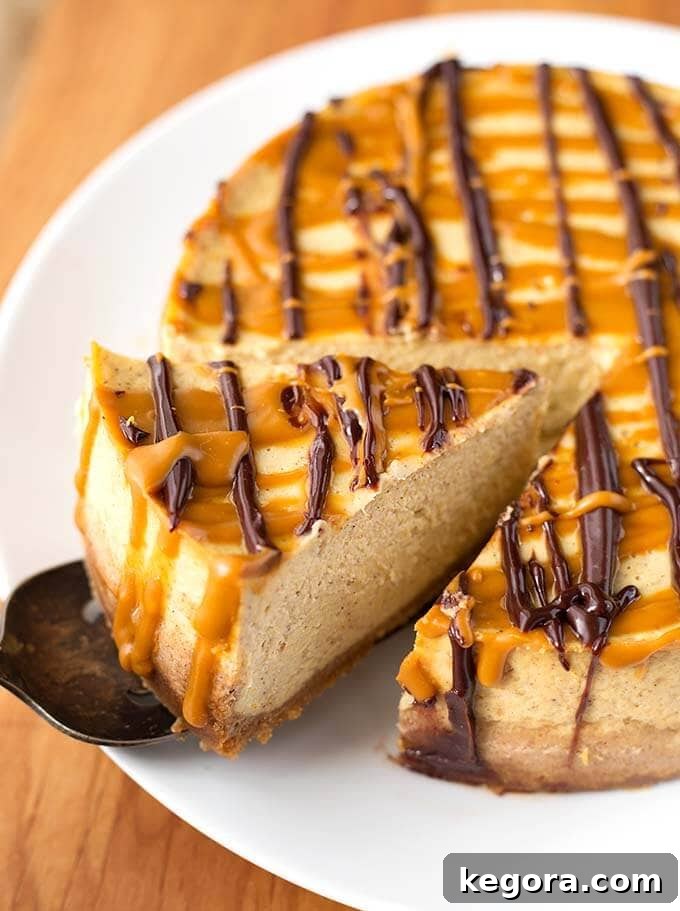 Decadent Instant Pot Pumpkin Cheesecake 3 Cut piece of Pumpkin Cheesecake on white plate