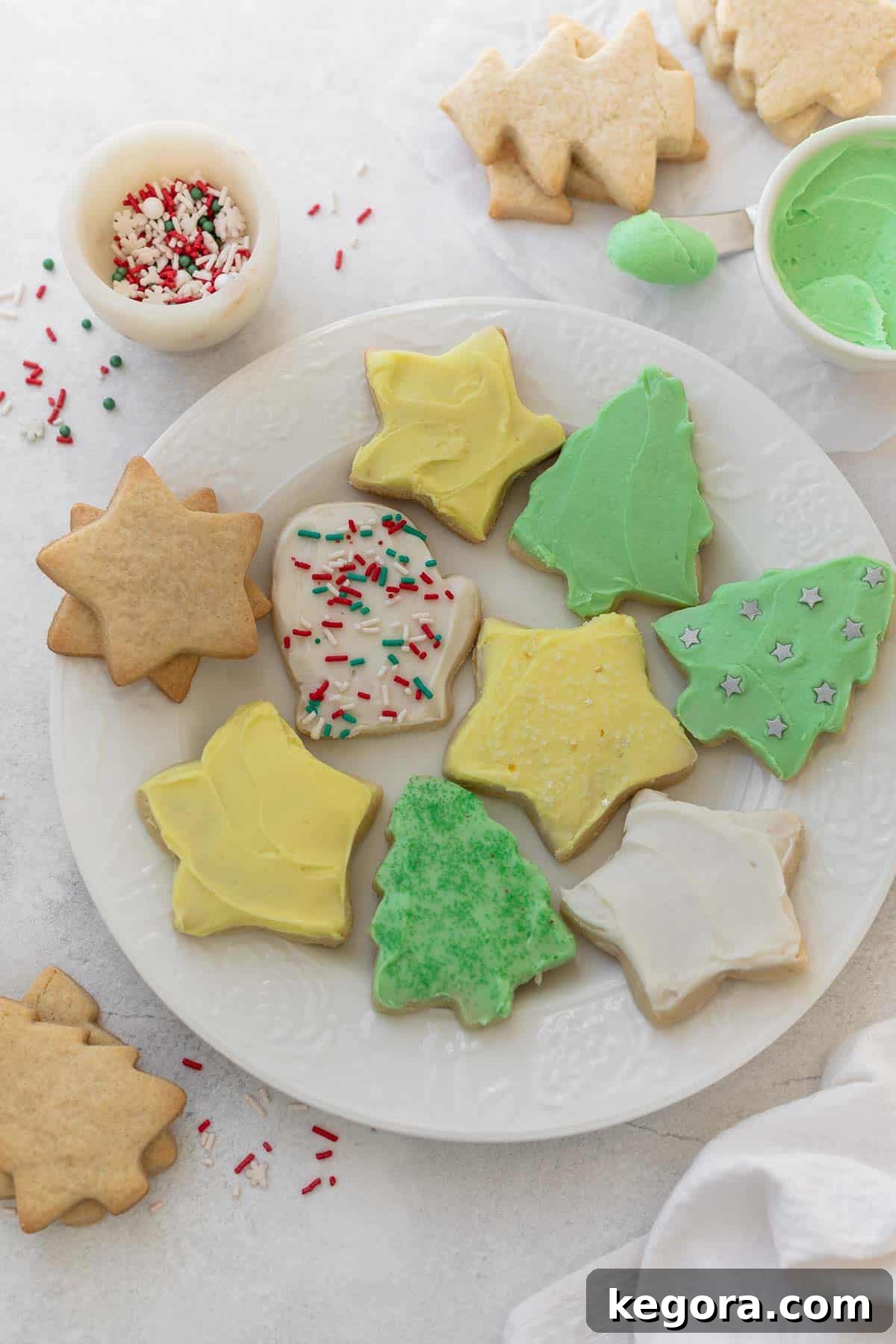 Perfect Gluten-Free Sugar Cookies 8 gluten free sugar cookies cut out into christmas shapes on white plate
