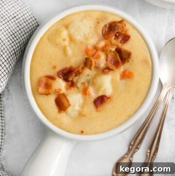 A close-up photo of creamy dairy-free potato soup in a bowl.