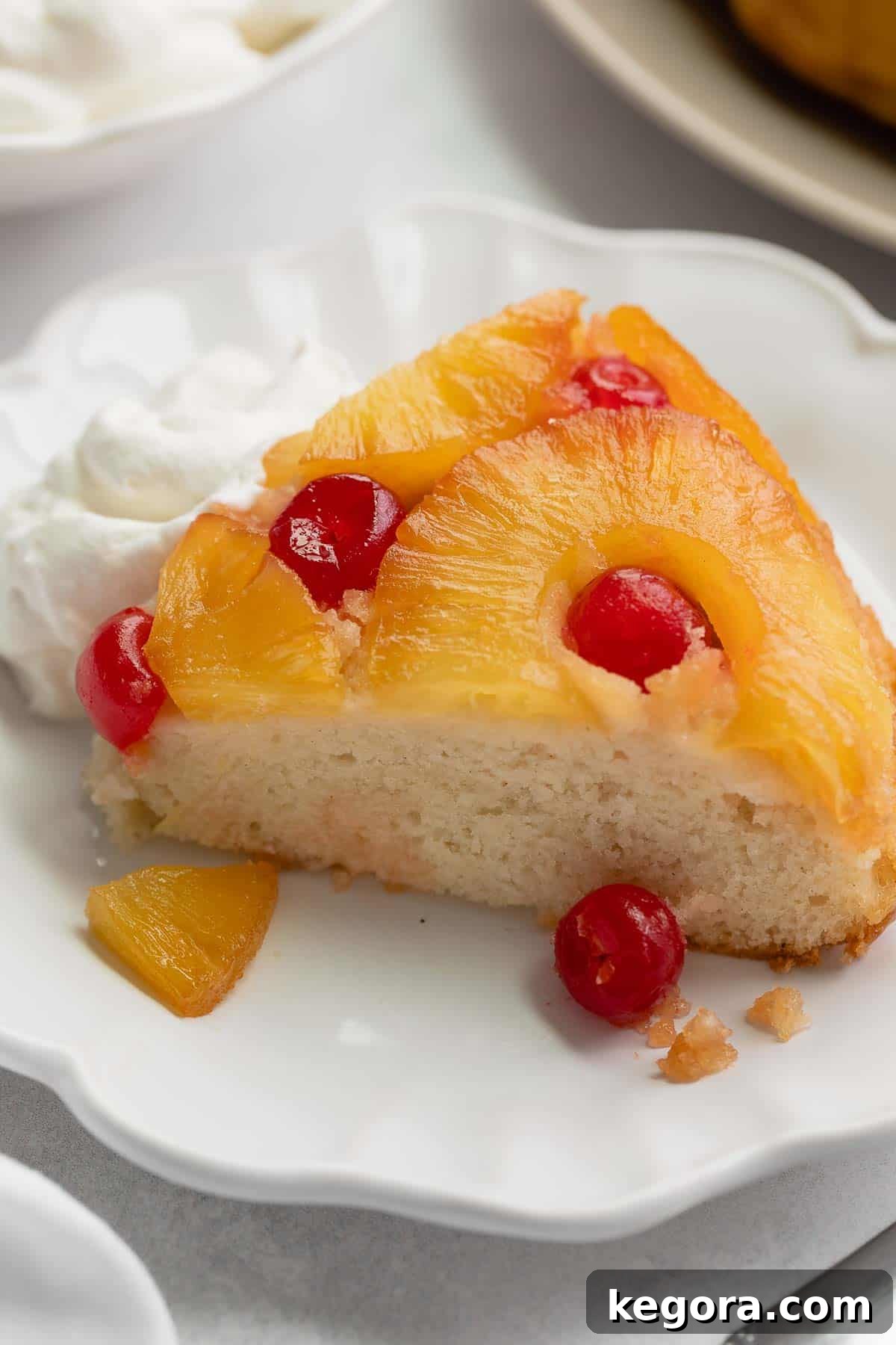 Luscious Gluten-Free Pineapple Upside-Down Cake 7 A slice of delicious gluten-free pineapple upside-down cake served on a plate.