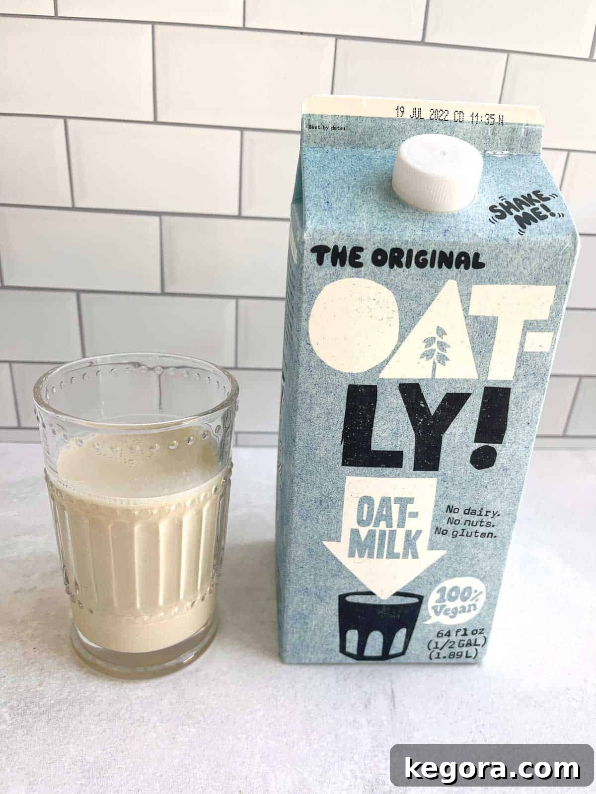 The Truth About Oat Milk and Gluten 3 glass of oat milk next to carton of oat milk
