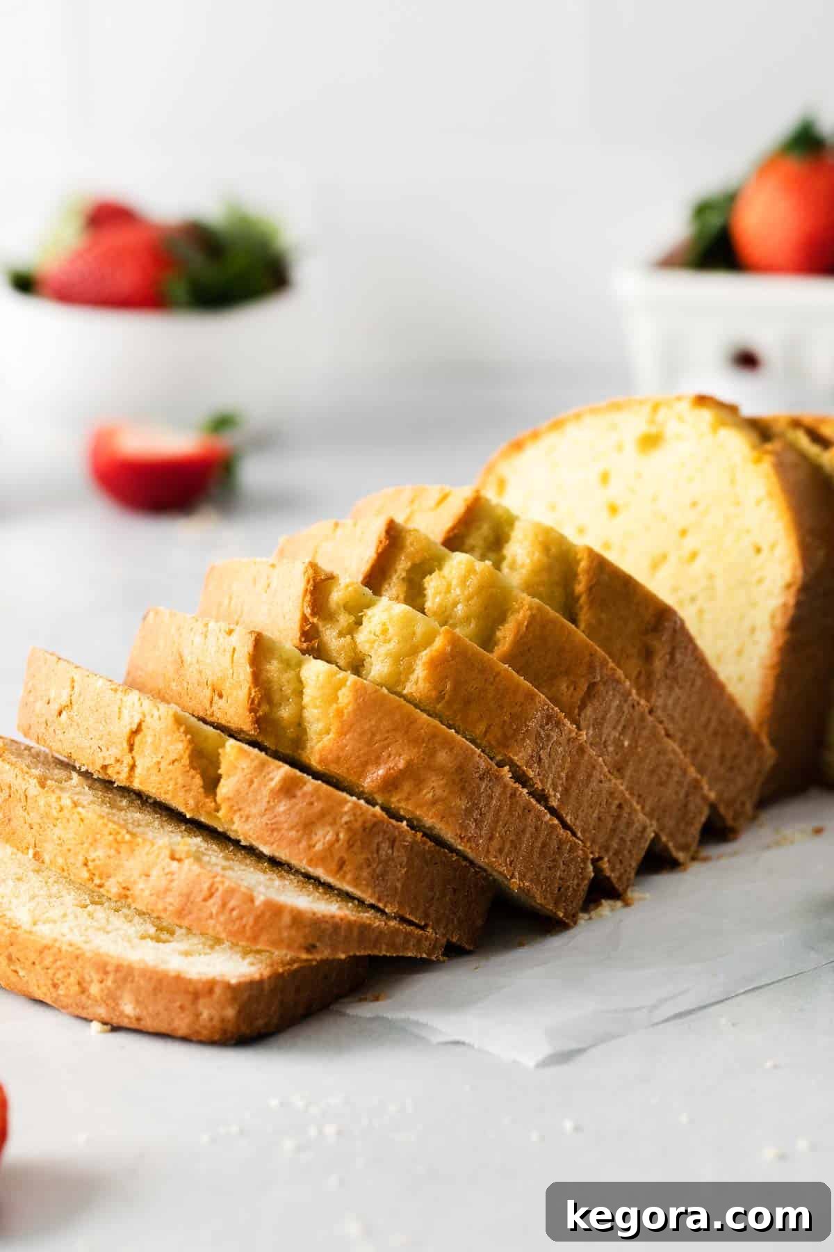 Seriously Delicious Gluten-Free Pound Cake 2 Perfectly sliced gluten-free pound cake displayed on a rustic wooden countertop, highlighting its moist and even crumb.